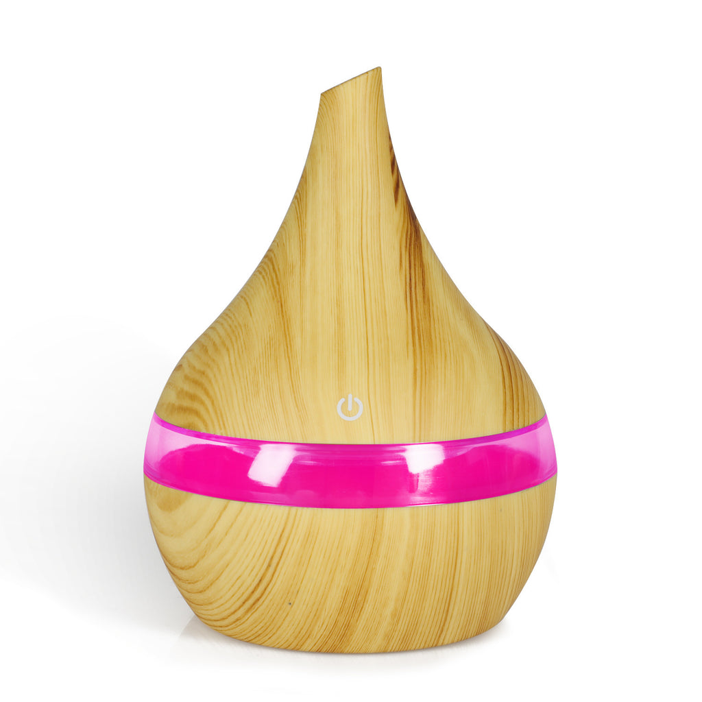 Wood grain aroma diffuser with pink LED light band and power button, light wood finish.