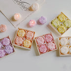 Rose-scented candle gift box with pastel rose-shaped candles in assorted colors