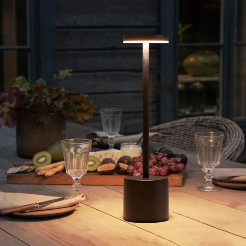 Portable cordless LED touch lamp with dark base, vertical stem, and glowing light bar