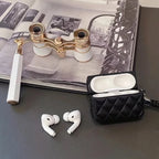 Black quilted leather AirPods case with lanyard strap, with AirPods earbuds visible