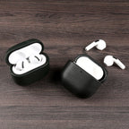 Dark green eco leather AirPods case with earbuds inside, open lid and black edge trim