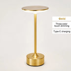 Gold cordless reading lamp with round top, tall stem, and cylindrical base
