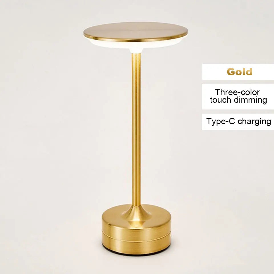 Gold cordless reading lamp with round top, tall stem, and cylindrical base