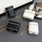 Wrist strap AirPods case set: dark (obsidian) and white (pearl) with gold chain.