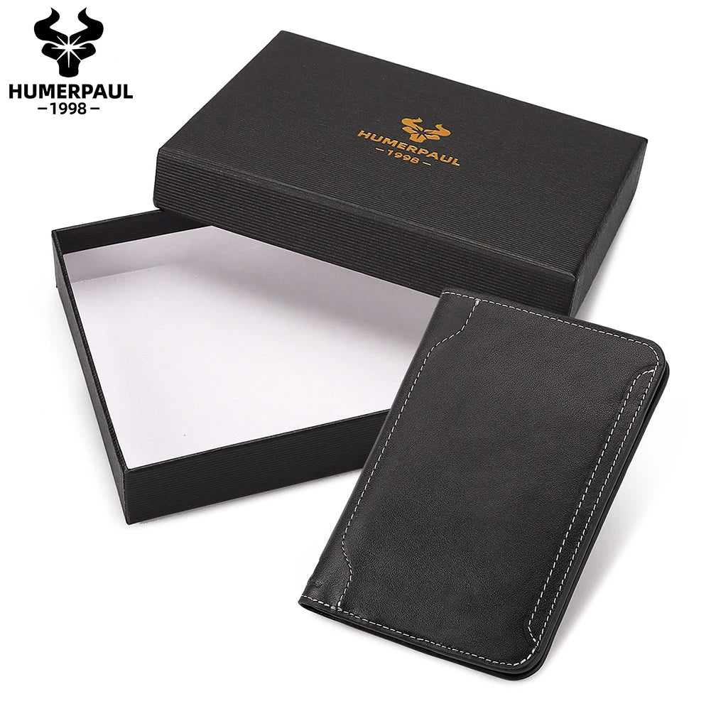 Dark slim leather passport wallet with contrast stitching, shown with gift box