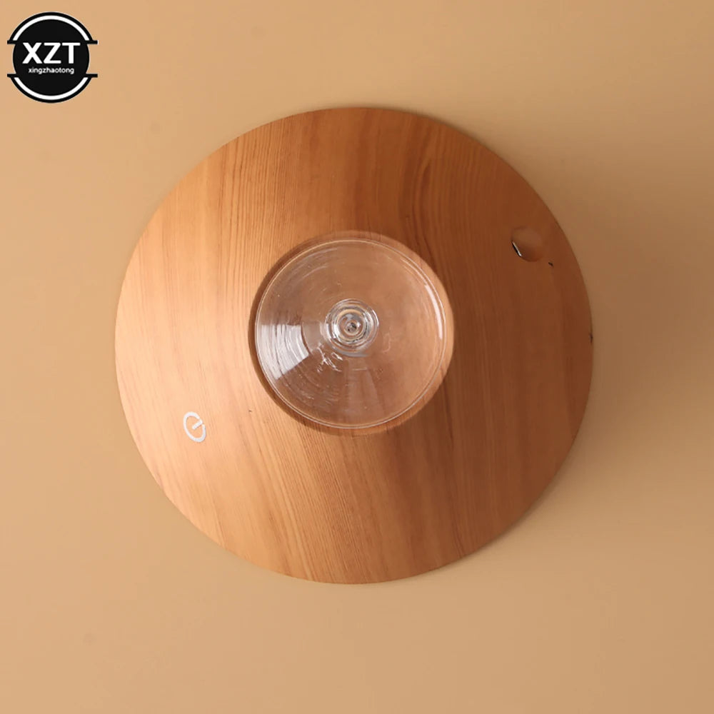 Wood grain aroma diffuser top view with clear round reservoir and power icon