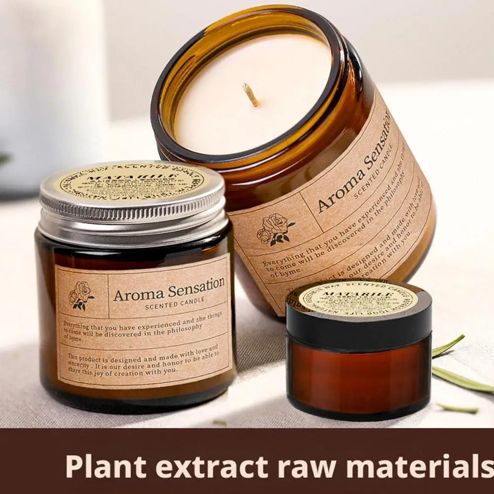 Amber scented candle set in glass jars, one lid open with white wax top and wick