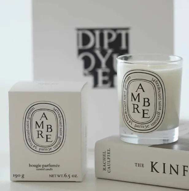 190g scented botanical candle in glass jar with AMBRE label and pale wax