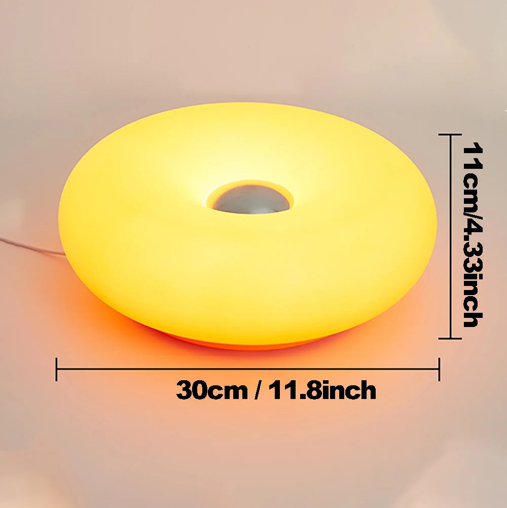 Yellow donut table lamp with center cutout, with size measurement markings