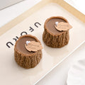 Two woodland tree stump candles with centered wicks and “Especially for you” tags