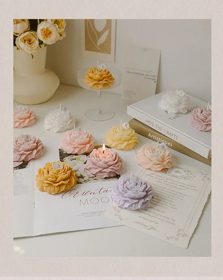Peony sculptural candle variety with lit wicks, floral shapes arranged with cards