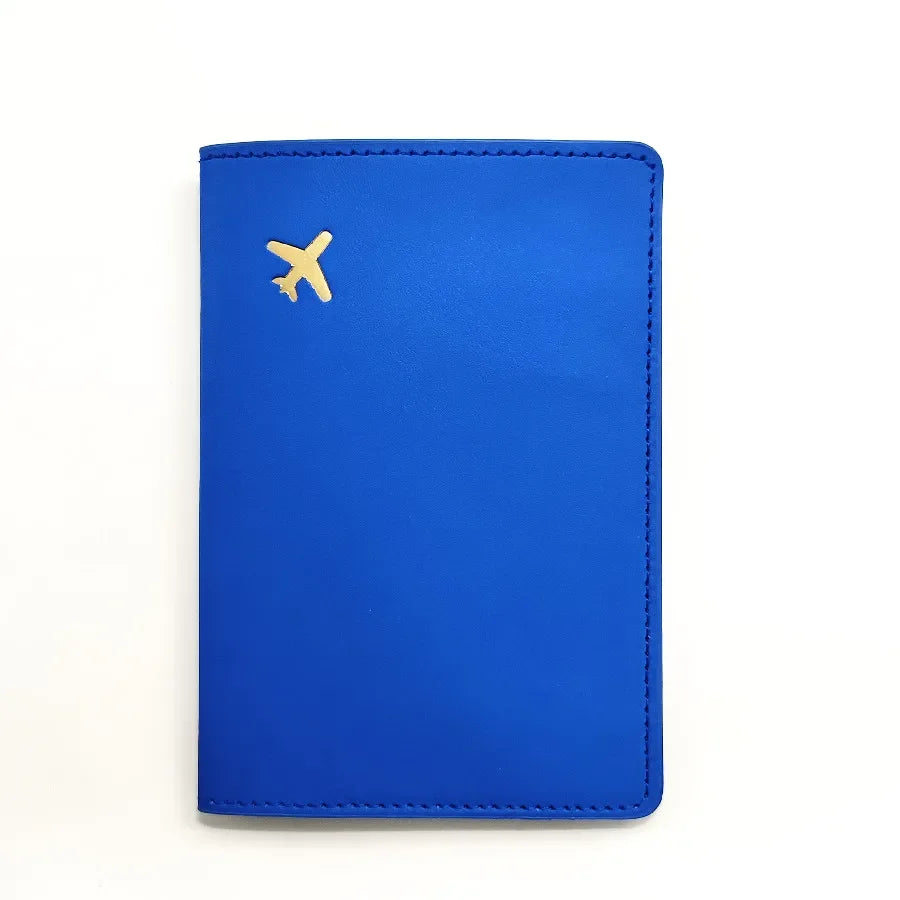 Midnight blue passport sleeve with gold plane emblem, smooth cover