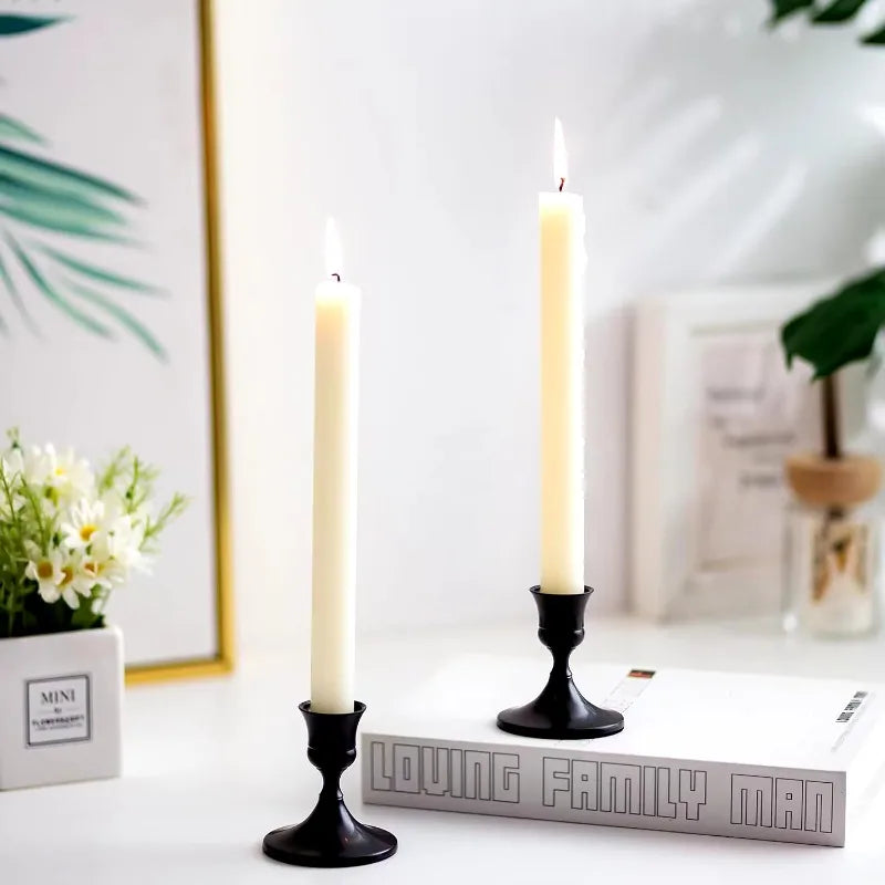 Black metal tabletop candle holder pair with flared tops and weighted bases