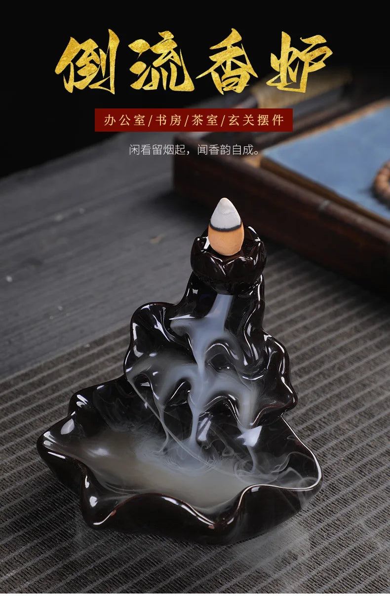 Backflow incense burner tower with cone incense and visible smoke flow over base