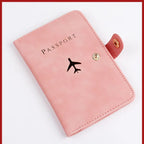 Blush pink passport folio with airplane logo, snap button closure, stitched border