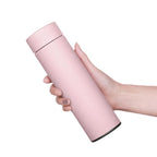 Heritage smart thermos flask, pink matte finish held in hand, smooth lid