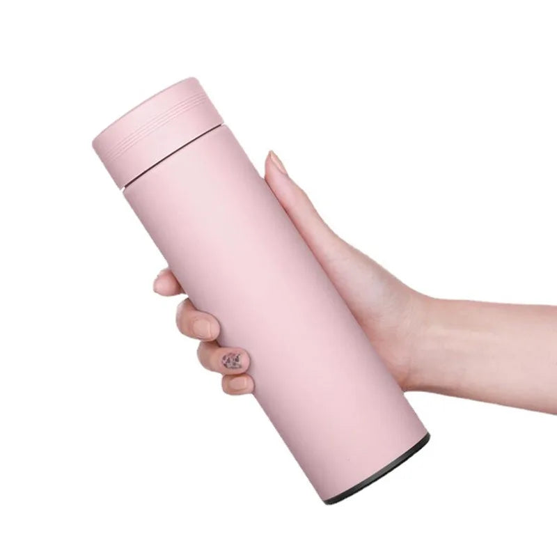 Heritage smart thermos flask, pink matte finish held in hand, smooth lid