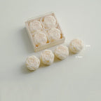 Ivory rose-shaped scented candles in a gift box with loose rose candles