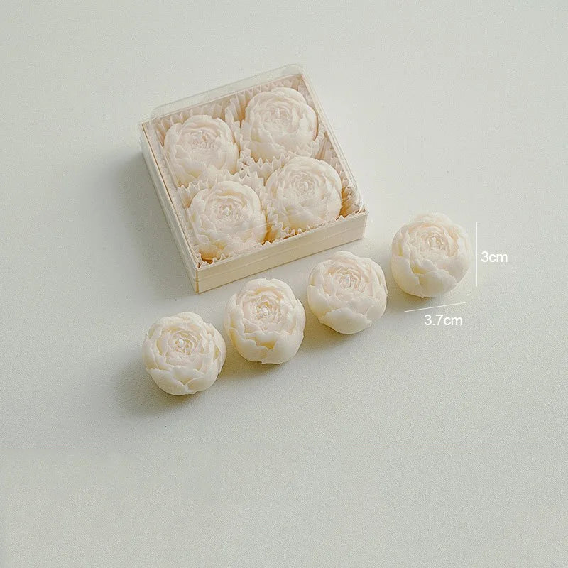 Ivory rose-shaped scented candles in a gift box with loose rose candles