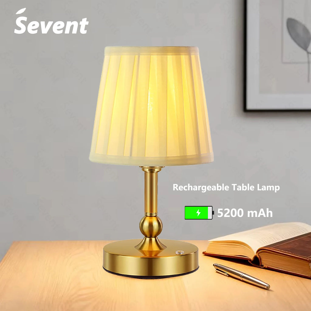 Champagne gold cordless LED touch table lamp with ribbed fabric shade and round base