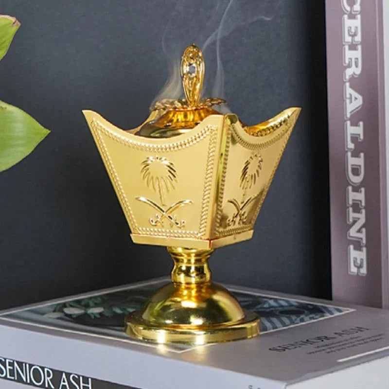 Gold metal incense holder with ornate crown shape and central finial, tabletop decor