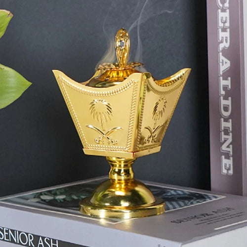 Gold crown-style incense holder with carved details and finial top, tabletop decor