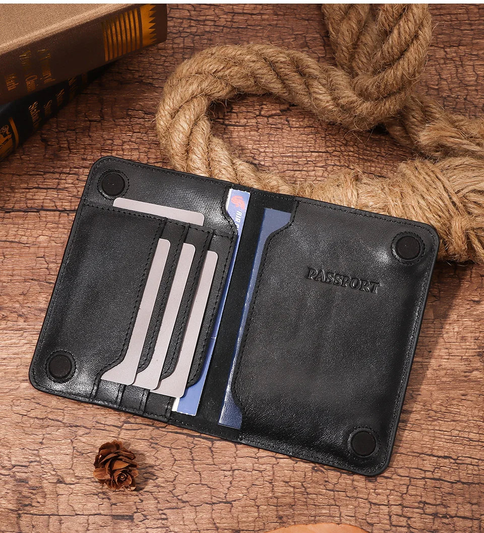 Dark leather slim passport wallet open, card slots visible, embossed “PASSPORT” panel