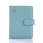 Light blue passport folio with snap strap closure and embossed airplane icon