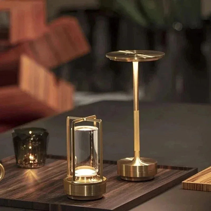 Cordless touch reading lamp with golden base and lantern-style clear light column