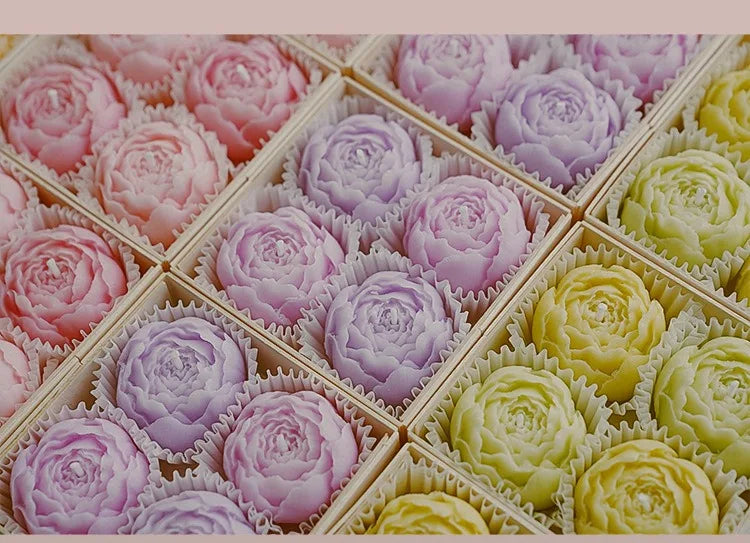 Assorted rose-shaped scented candles in gift tray, including lilac and yellow