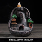 Resin landscape incense burner: circular cave with green trees, orange-roof houses, purple-topped incense