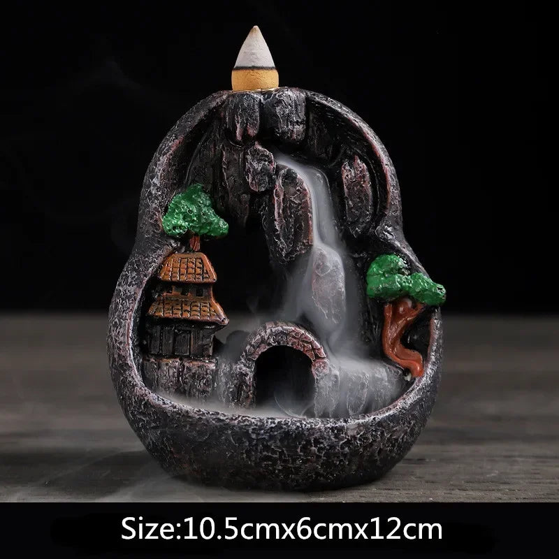 Resin landscape incense burner: circular cave with green trees, orange-roof houses, purple-topped incense