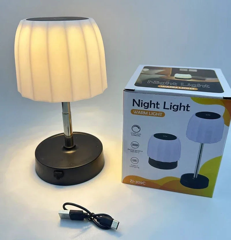 Cordless LED lamp with warm-lit pleated white shade and round black base