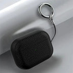 Black leather AirPods keyring case close-up with small status dot and metal key ring