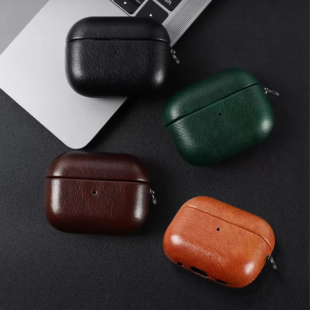 Orange, dark brown, and black leather AirPods cases with metal keychain clips