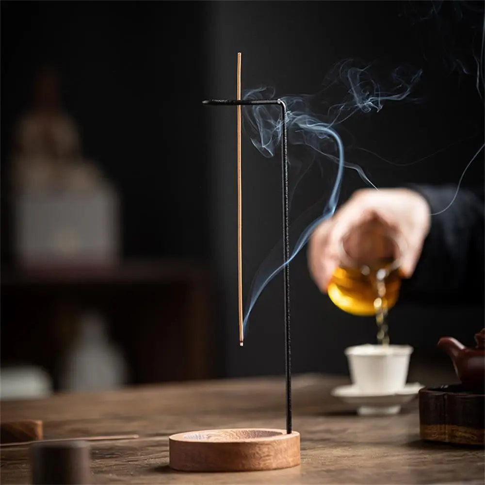 Walnut-black inverted incense holder with incense stick and rising smoke
