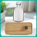 Essential oil diffuser with clear glass bottle and light wood grain base, round control knob