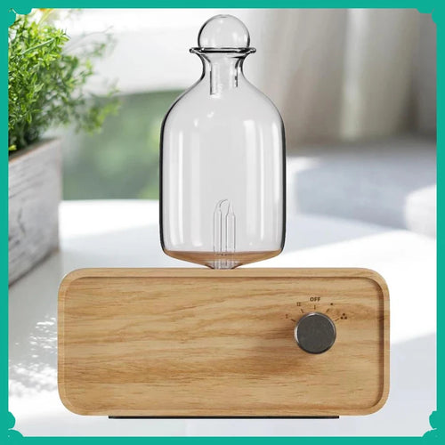 Essential oil diffuser with clear glass bottle and light wood grain base, round control knob