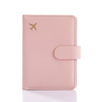 Blush pink passport folio with matching strap closure and decorative edge stitching