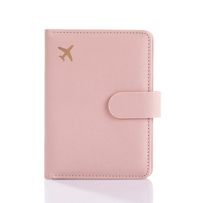 Blush pink passport folio with matching strap closure and decorative edge stitching