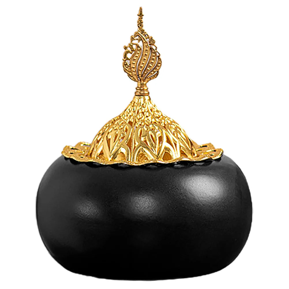 Ceramic oud burner with black dome base and gold openwork lid featuring a finial