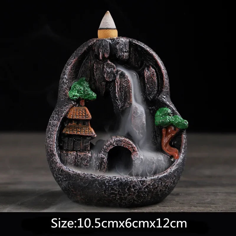 Round waterfall incense burner, dark stone bowl with green trees and orange lanterns