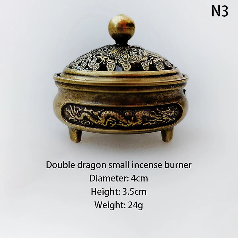 Small double-dragon incense burner with domed lid and round foot, gold and dark finish