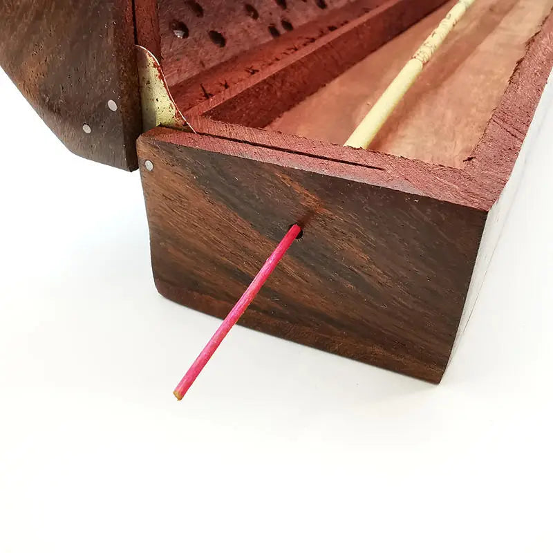 Carved rosewood incense box side view with open compartment and red incense stick