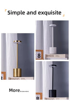 LED touch lamp with gold stem and dark base, glowing top; angled close-up