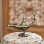 Brass incense burner lamp with conical top and engraved base on pedestal