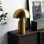 Gold mushroom table lamp with dome shade and gold conical body