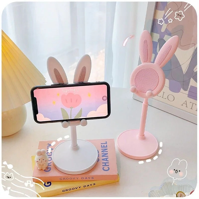 Blush pink rabbit lift phone stand holding a phone on a raised round platform