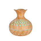 Light wood grain mini vase humidifier with teal light dots in the cutout vent pattern