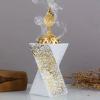 White resin bakhoor burner with gold finial, engraved Arabic panel, and smoke plume